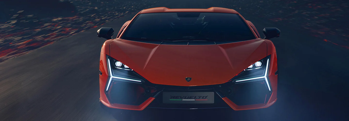 Front view of a Lamborghini driving at night