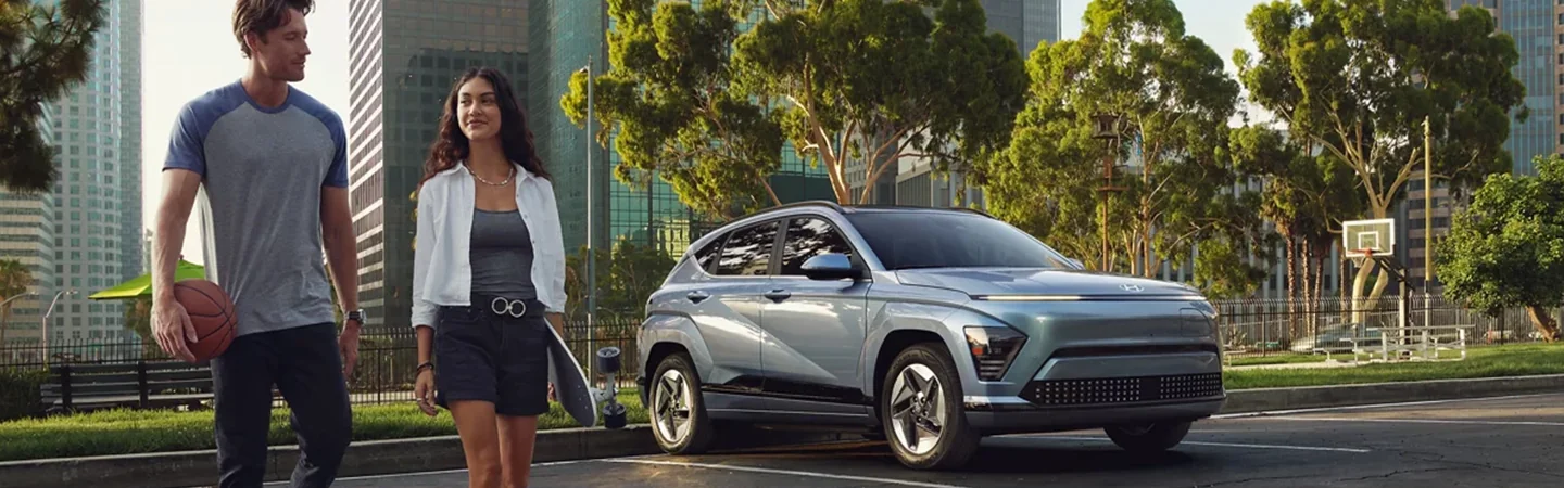 Hyundai Kona Electric parked with woman walking away