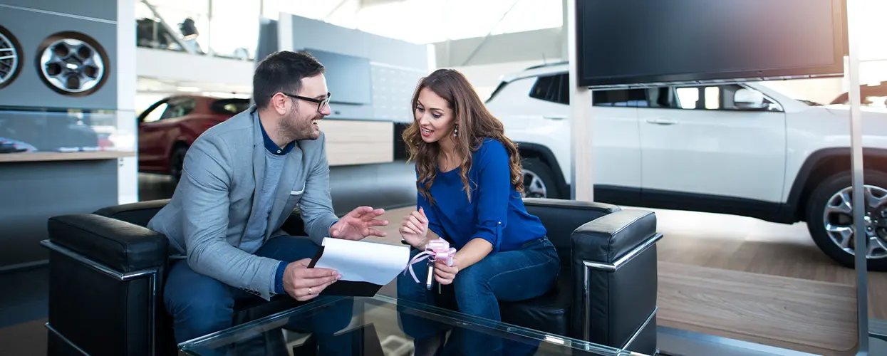 discussing new car in showroom