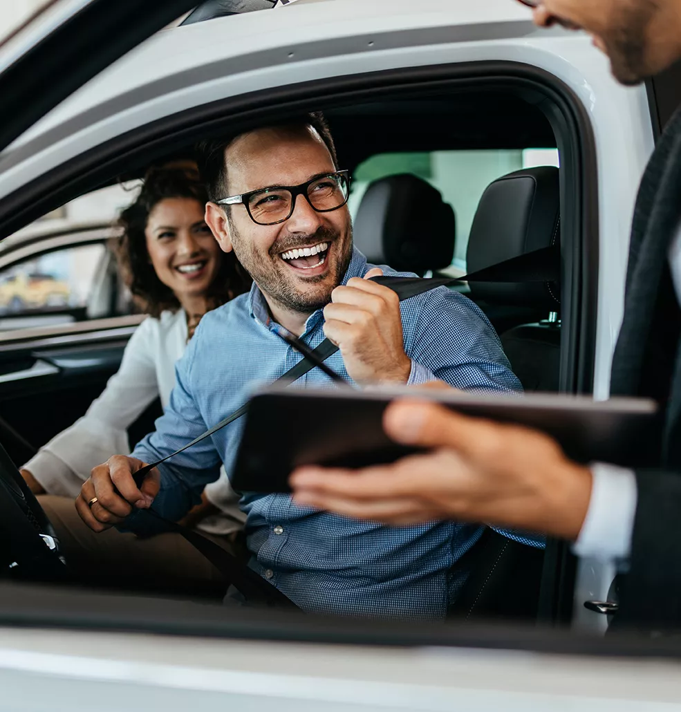 Couple sitting inside a new Dodge vehicle