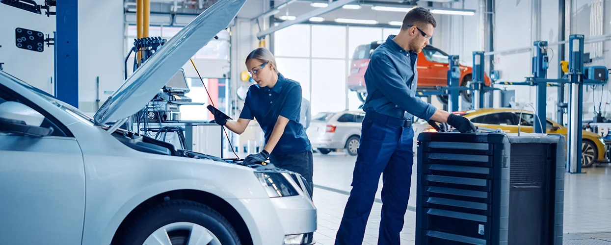 Two Hyundai service techs working on a engine