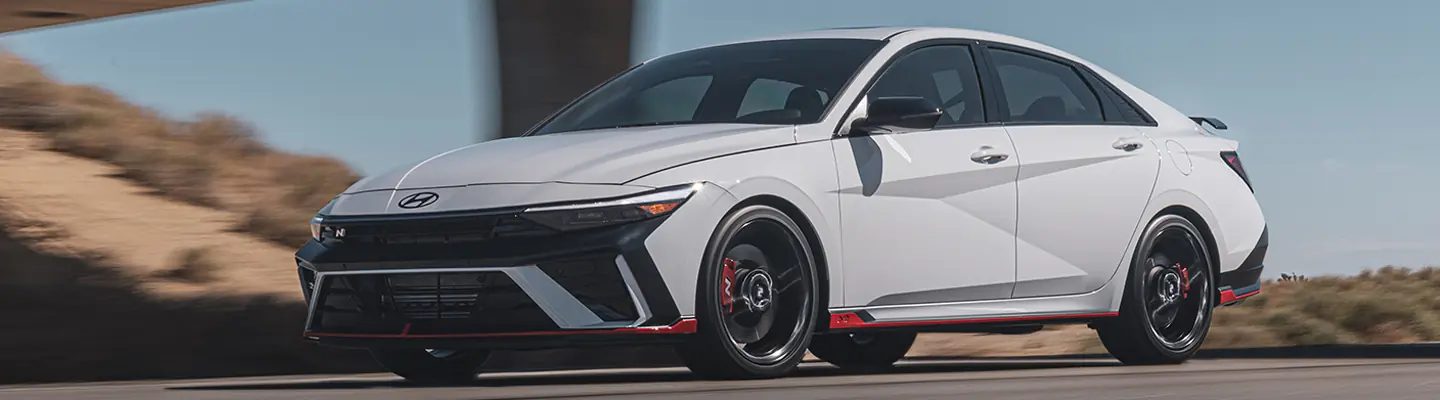 A gray 2025 Hyundai sedan driving on the road