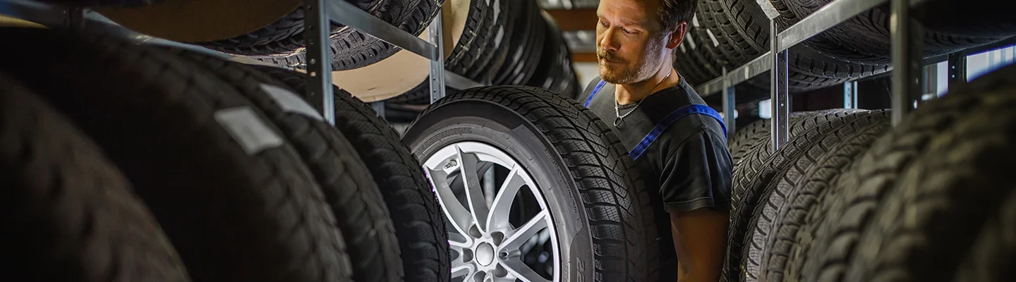 Auto mechanic working on tires