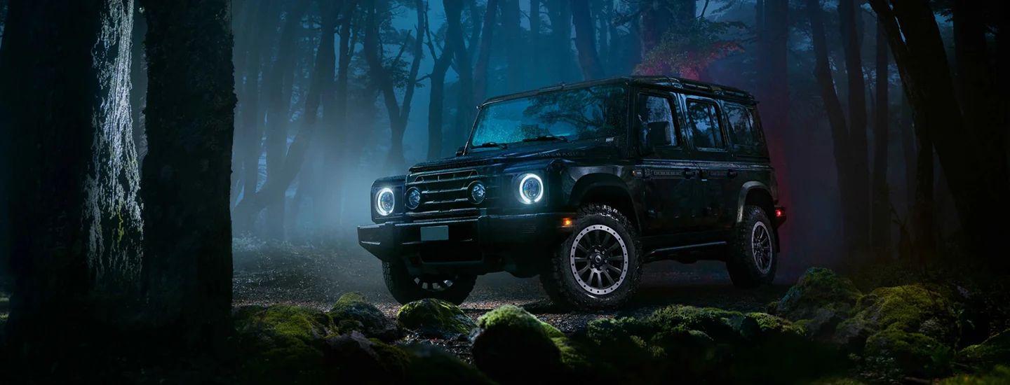 front view of a 2025 INEOS Grenadier Station Wagon 1924 Limited Edition at night offroad