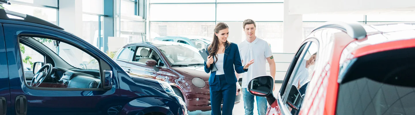man and woman walking around dealership