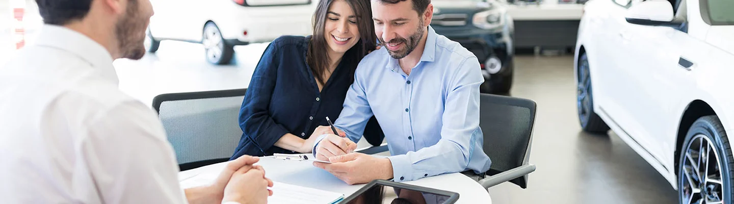 Sales person helping customers go over there Financing Options