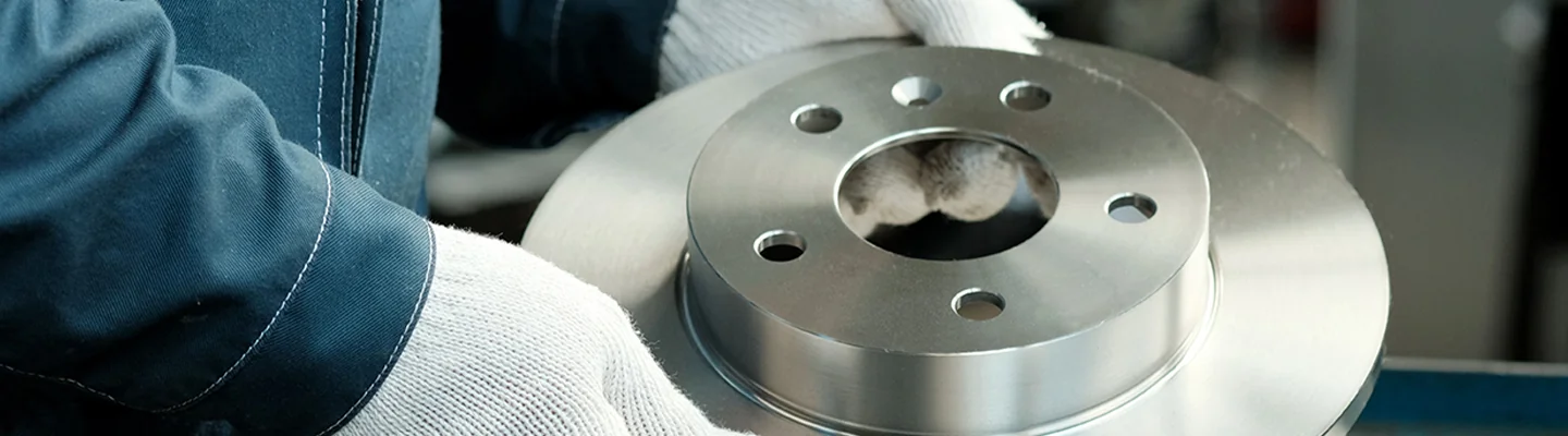 auto mechanic working on brakes