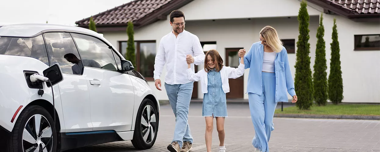 Happy family walking to there car changing