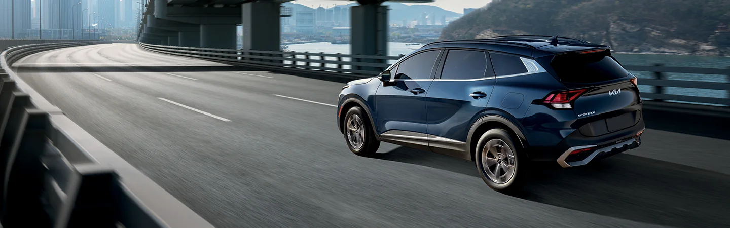 2025 Kia Sportage Hybrid driving on a bridge