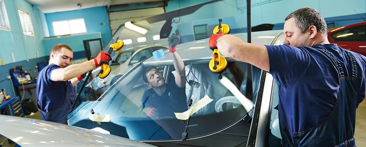 Service techs installing a new windshield