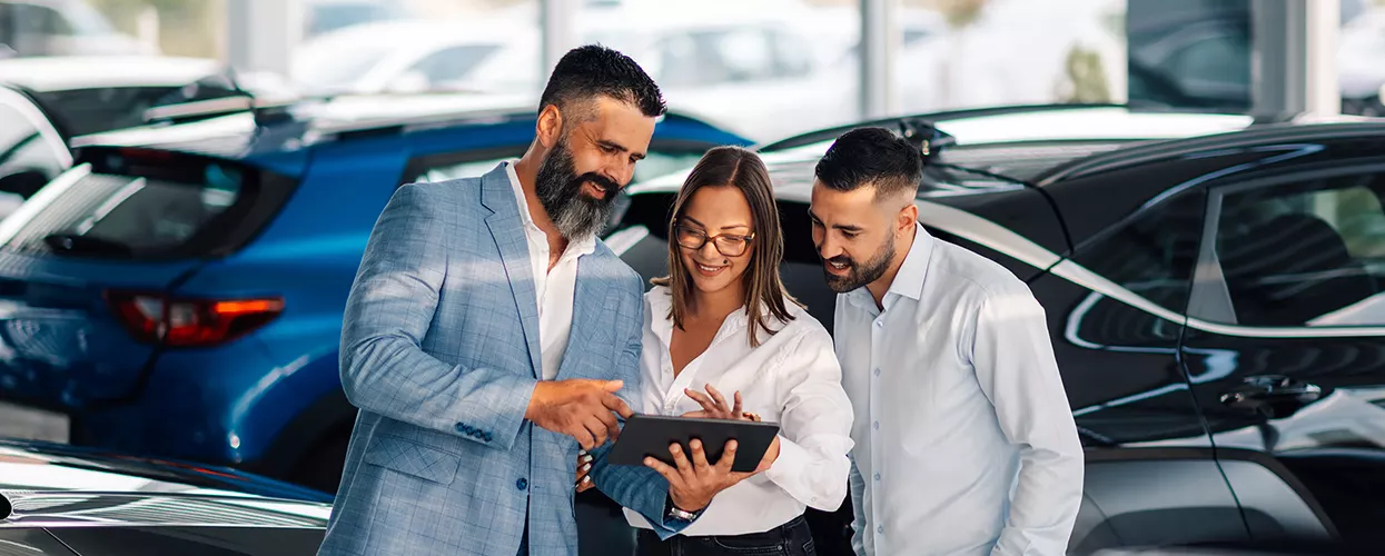 Sales peroson showing customers pricing on new EVs