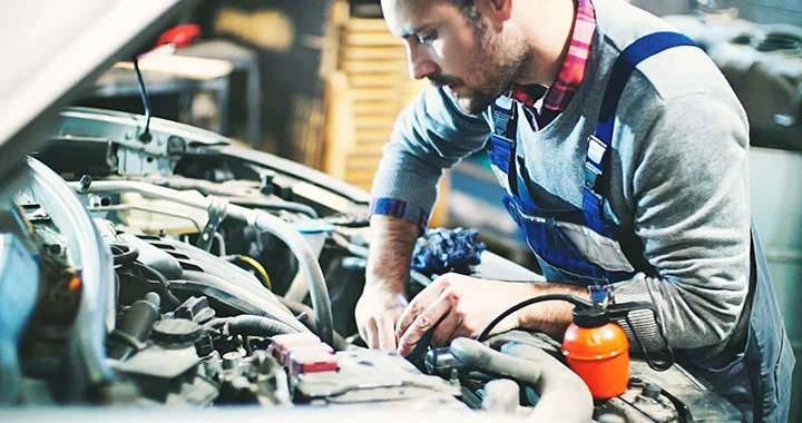 auto mechanic working on car