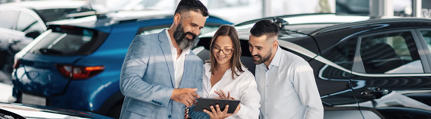people shopping in car showroom