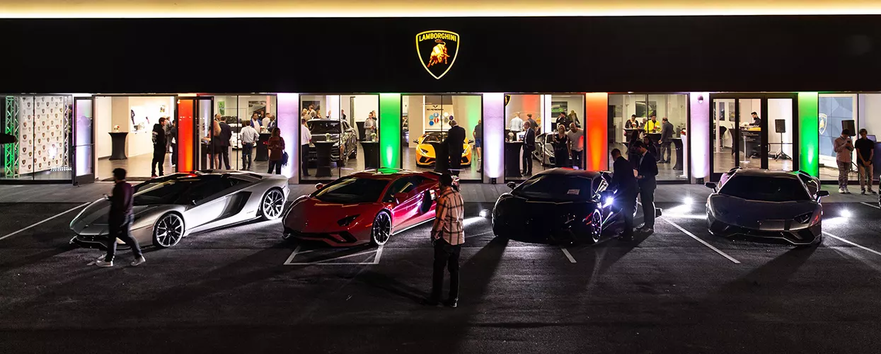 Lamborghini vehicle lineup outside of a Lamborghini dealership