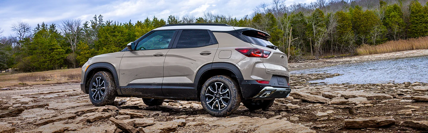 Side view of 2026 Chevrolet Trailblazer parked on rocks near the water
