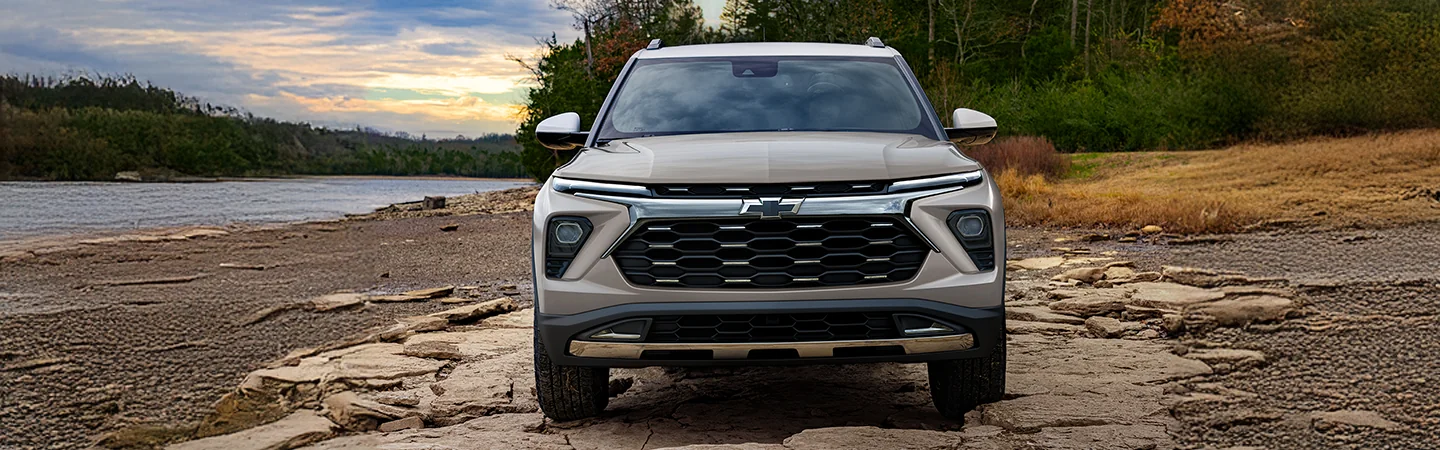 Front view of the 2026 Chevrolet Trailblazer parked near a beach with a sunset in the background