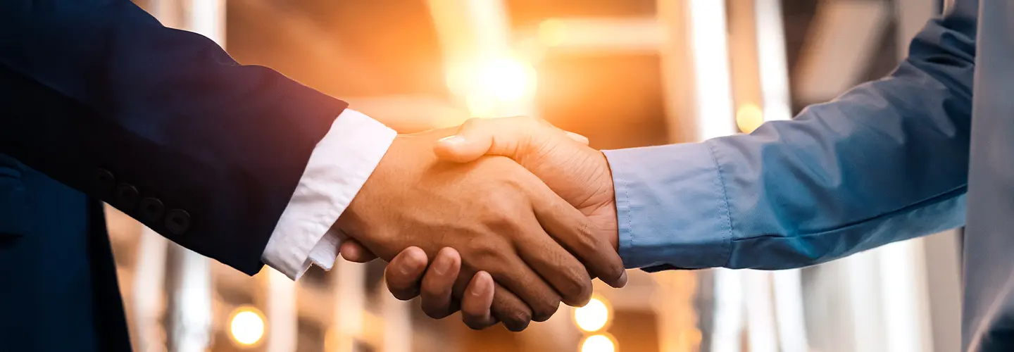 shaking hands at our dealership showroom