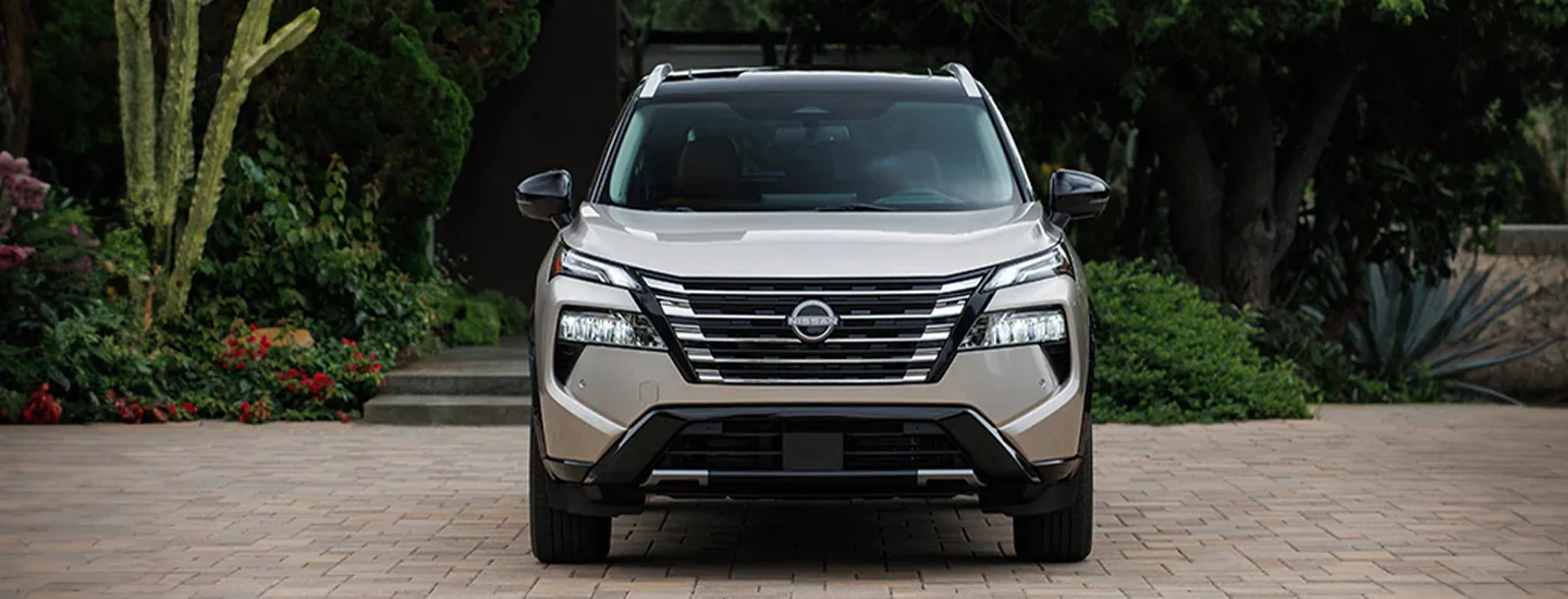 Front view of a parked tan 2024 Nissan Rogue