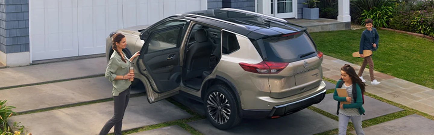 Side top view of a parked 2024 Nissan Rogue in a house driveway