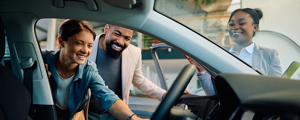 Sales person showing customers a Brand-New Kia Model