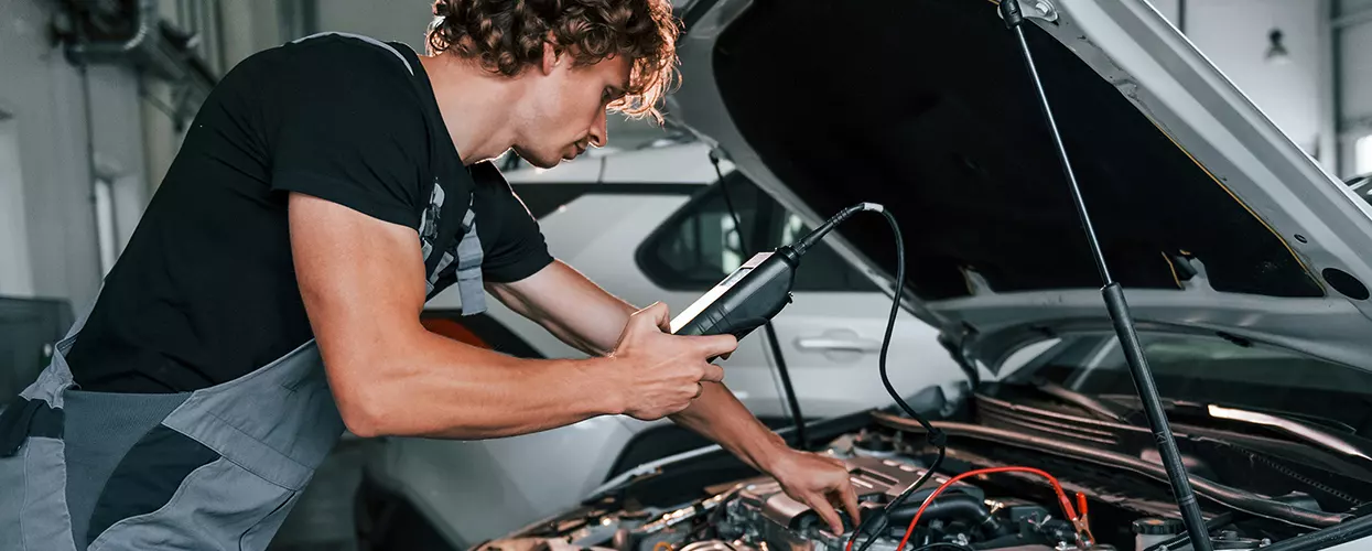 Service mechanic testing a battery