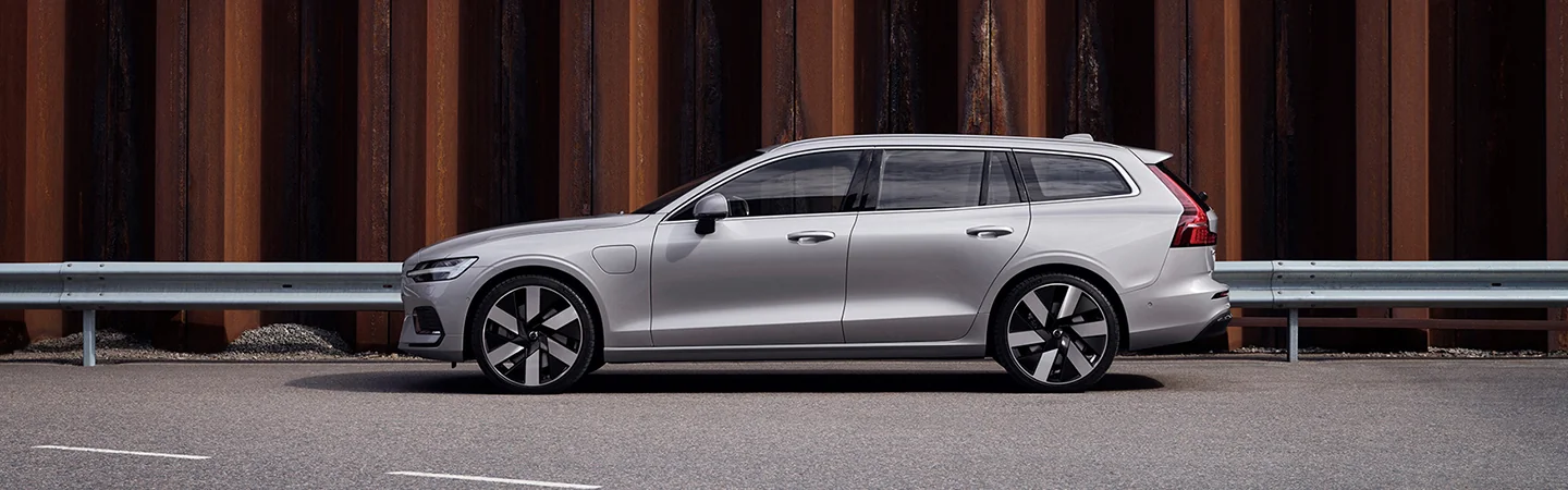 driver side view parked against railing and wall of steel2025 Volvo V60 Cross Country Plus