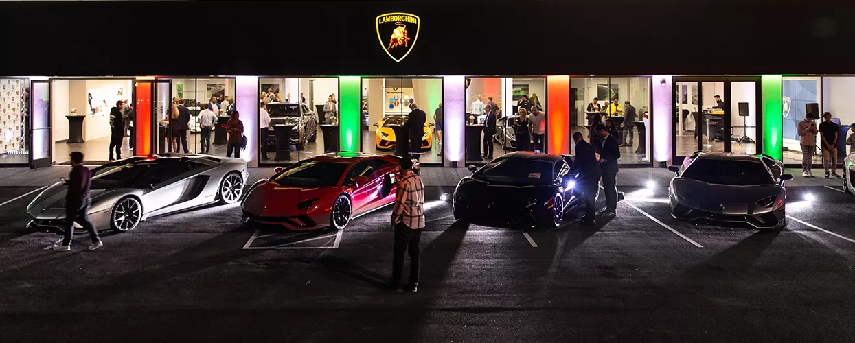 Lamborghini vehicle lineup outside of a Lamborghini dealership