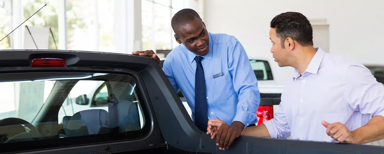 Two people looking at a new RAM Truck