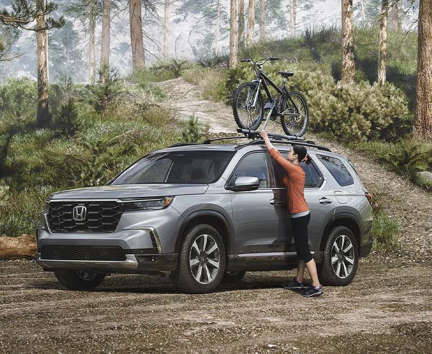 2026 Honda Pilot exterior view loading a bike on top bike rack