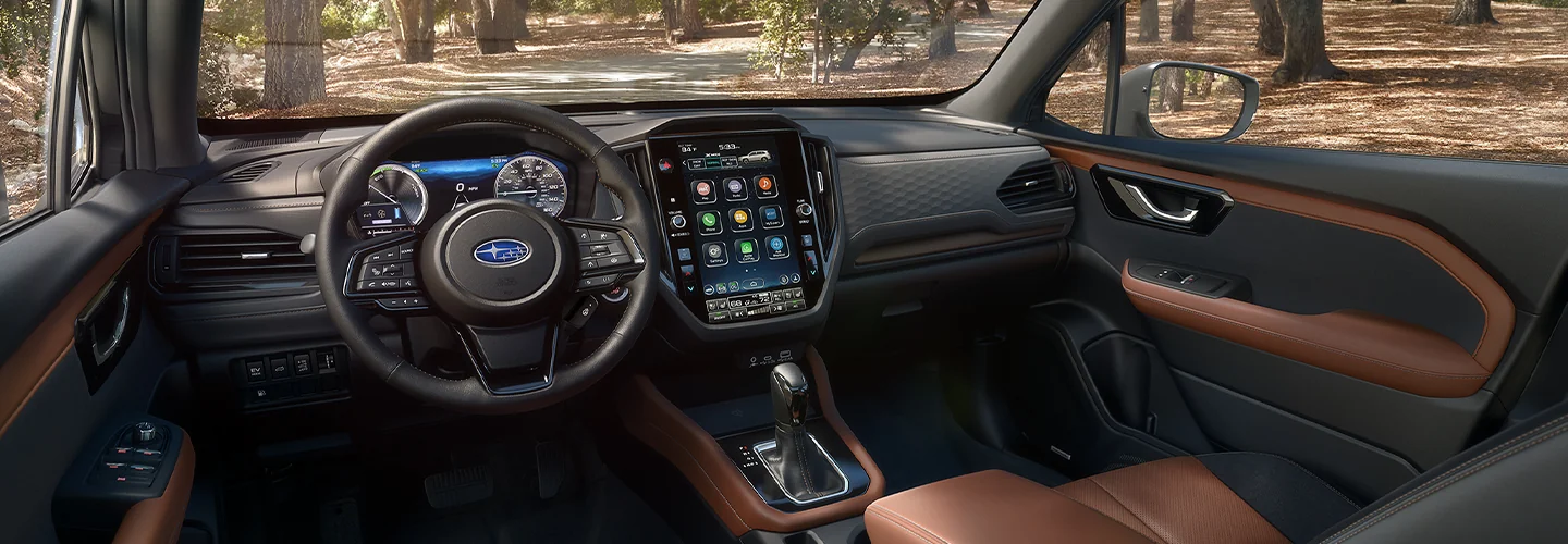 Interior view of the dashboard and tech of the 2025 Subaru Forester parked in a forest in South Chesterfield, VA.