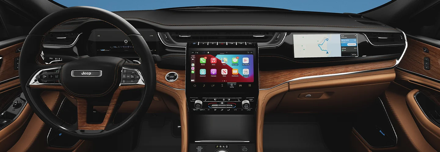 Interior view of the dashboard and tech of a 2025 Jeep Grand Cherokee