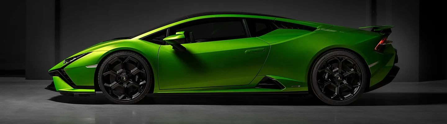 driver side view of a green Lamborghini Huracán Tecnica
