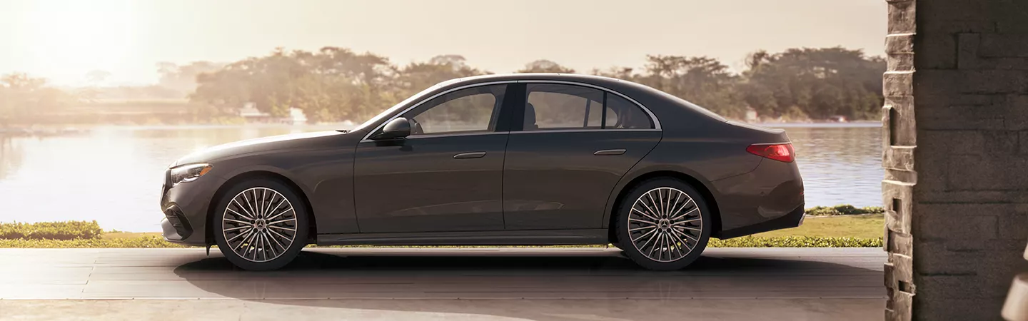 Side view of the 2025 Mercedes-Benz E-Class with a lake in the background