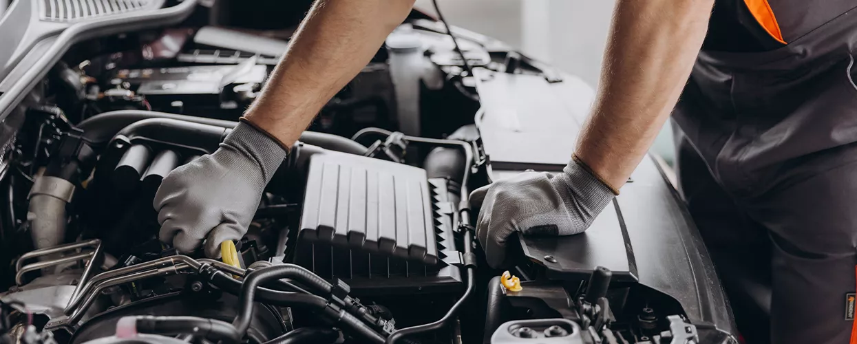 Service mechanic working under a cars hood