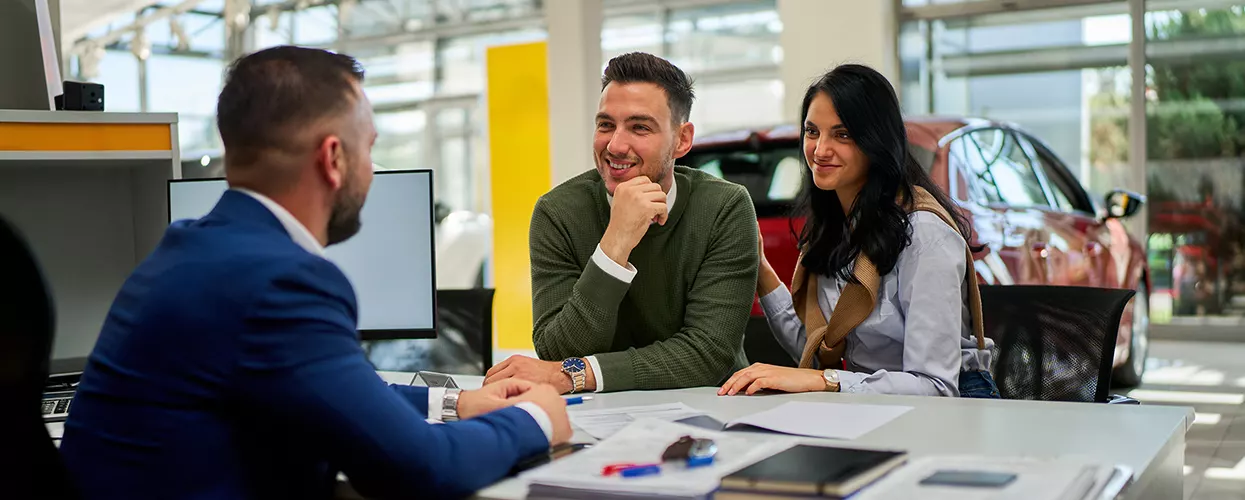 Car salesman talking to a customer about a contract