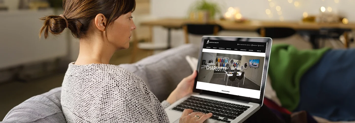person on a laptop browsing the Lamborghini of Charlotte website shopping online