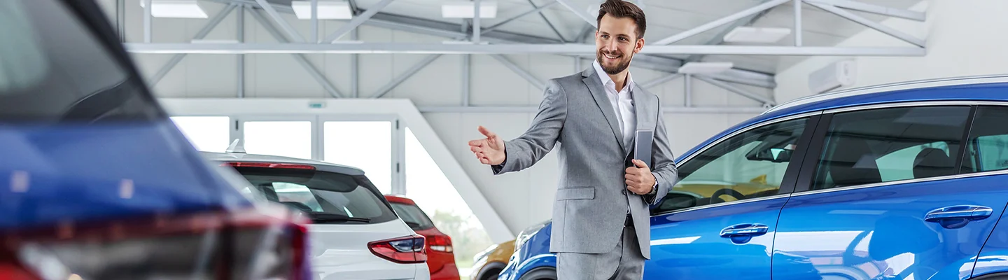 Sale person showing off new cars
