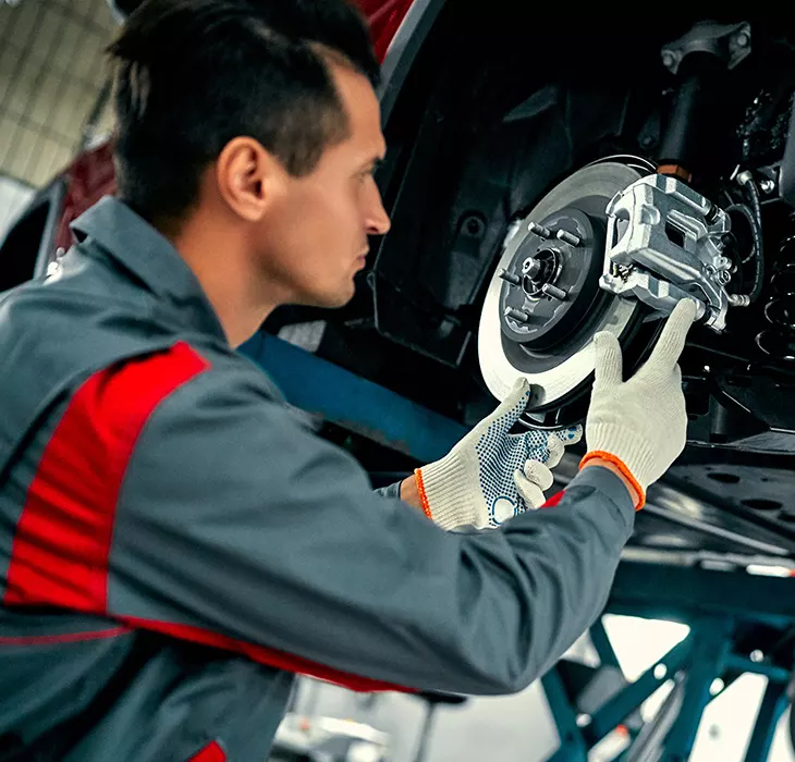 Technician servicing a vehicle