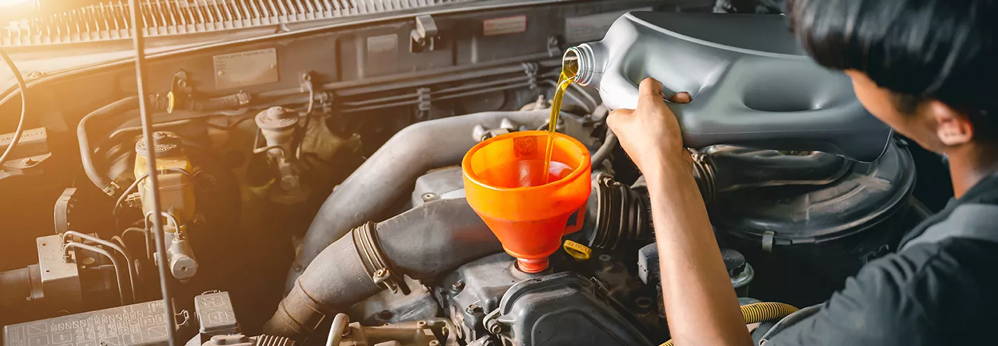 pouring fresh oil into crankcase