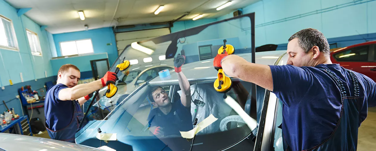 3 service techs installing a new windshield