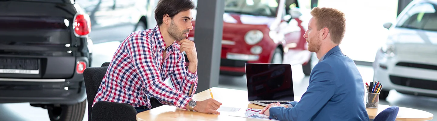 two people discussing car purhcase in dealership