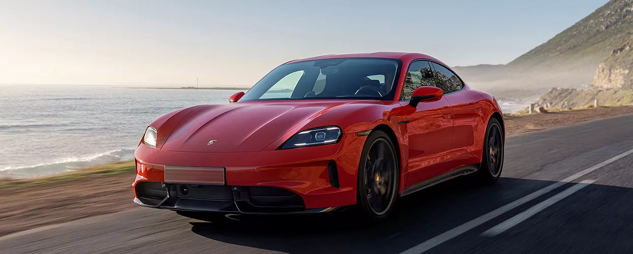 Porsche vehicle driving on the coast