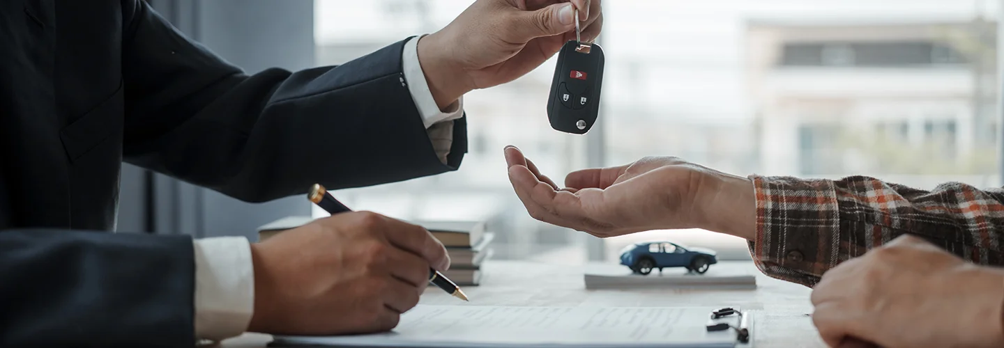 Car keys being handed over to another person