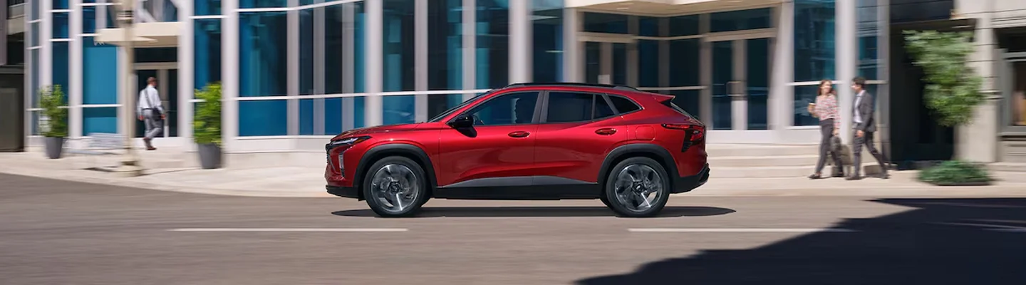 Red Chevrolet driving in the city