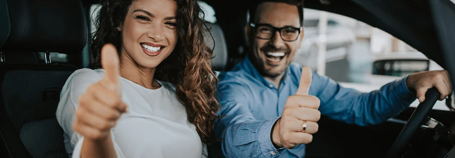 people thumbs uping in car