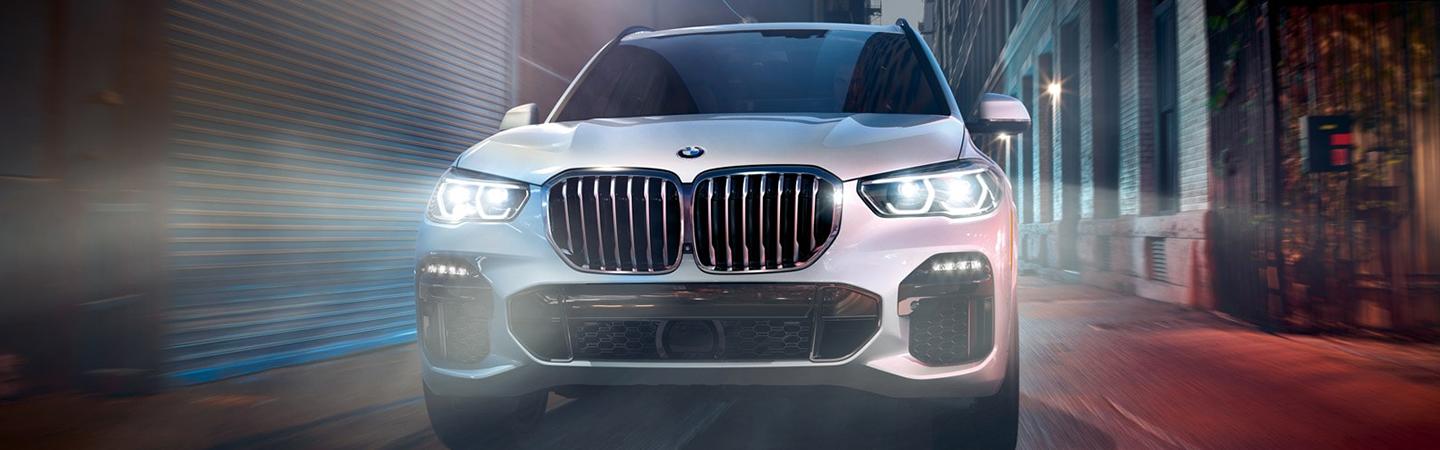 Front view of a 2021 BMW X5 driving in the city