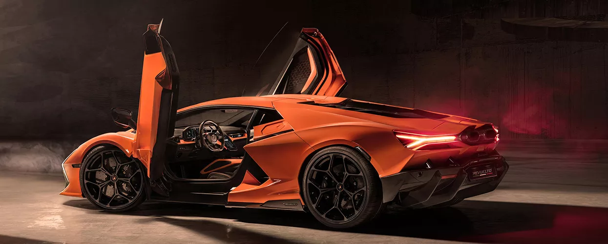 Orange Lamborghini Revuelto supercar with scissor doors open, showcasing exotic design