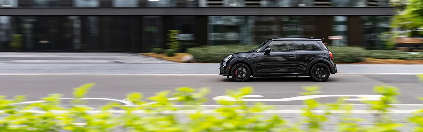 black 2025 MINI Cooper 2 Door driving in city