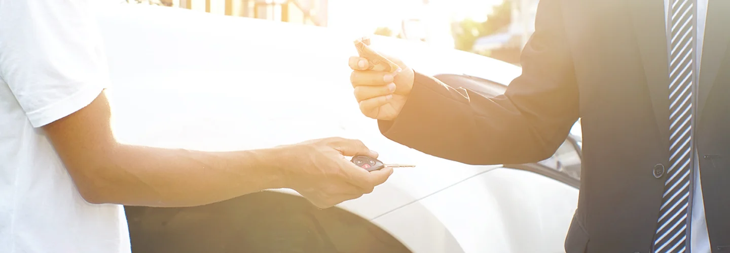 Sales person being handed there new keys to there car