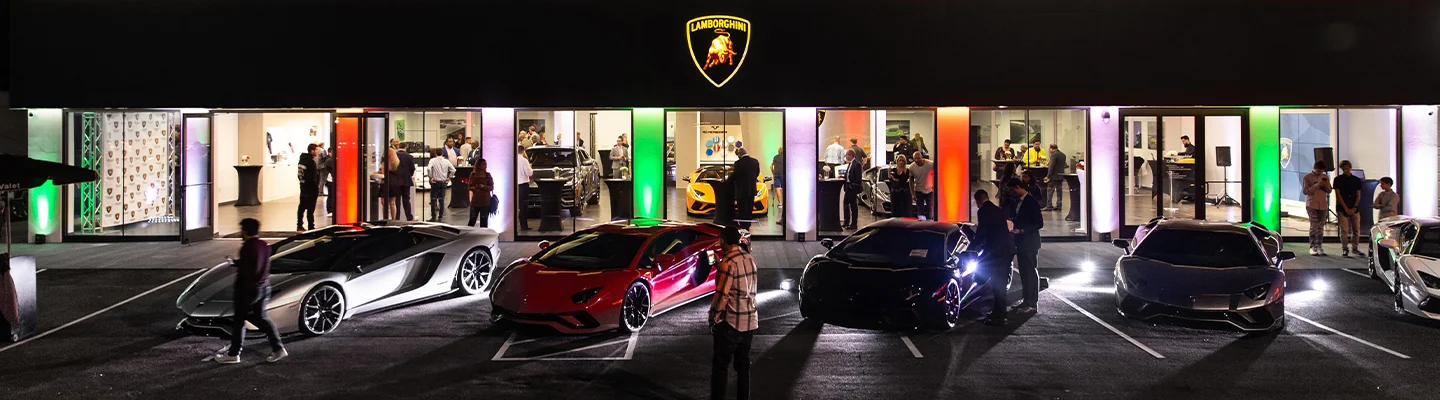 Line up of Lamborghinis infront of a Lamborghini store front